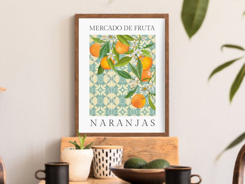 May include: A framed print with a vintage illustration of orange blossoms and fruit on a blue and white tiled background. The text "Mercado de Fruta Naranjas" is printed below the illustration.