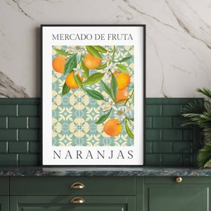 May include: A framed print with a vintage style illustration of oranges and blossoms on a tiled background. The text "Mercado de Fruta" and "Naranjas" is printed in black at the top and bottom of the image.