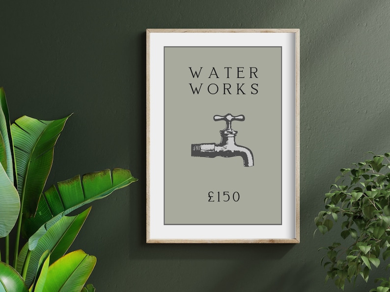 May include: A framed wall art print featuring a sage green background with the black text WATER WORKS at the top, a black illustration of a water faucet in the center, and the text &pound;150 in black at the bottom, all enclosed in a light wood frame.