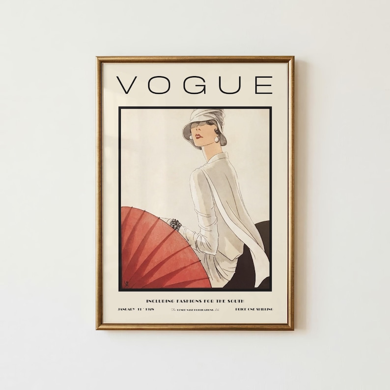Może przedstawiać: Oprawiony wydruk okładki magazynu Vogue ze stycznia 1929 roku z ilustracją osoby w białym topie i kapeluszu, trzymającej duży czerwony parasol. Tekst głosi VOGUE, INCLUDING FASHIONS FOR THE SOUTH, JANUARY 1929, PRICE ONE SHILLING.