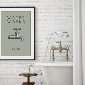 May include: A framed wall art print featuring a sage green background with the black text WATER WORKS, a black and white illustration of a water faucet, and the text &pound;150 centered at the bottom. The print is enclosed in a thin black frame.