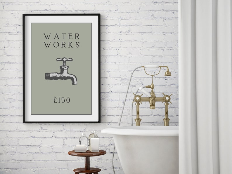 May include: A framed wall art print featuring a sage green background with the black text WATER WORKS, a black and white illustration of a water faucet, and the text &pound;150 centered at the bottom. The print is enclosed in a thin black frame.