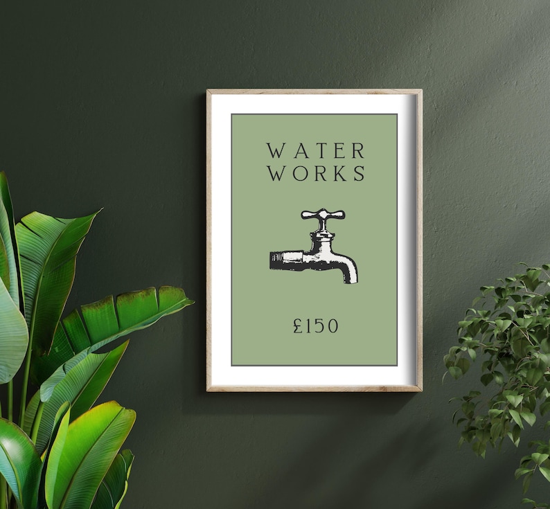 May include: A framed wall art print featuring a sage green background with the black text WATER WORKS centered at the top, a black and white illustration of a water faucet in the middle, and the text &pound;150 printed in black at the bottom.