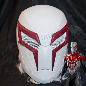 May include: White and red Spider-Man mask with a mesh eye area. The mask is a replica of the character's mask from the Spider-Man: Into the Spider-Verse movie.