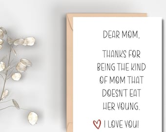 May include: A white card with black text that reads "Dear Mom, Thanks for being the kind of mom that doesn't eat her young. I love you!" with a red heart.