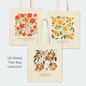 May include: Three tote bags with floral designs. The first bag features a red and orange poppy design with the text "CALIFORNIA - CALIFORNIA POPPY". The second bag features a yellow hibiscus design with the text "HAWAII - HIBISCUS". The third bag features an orange blossom design with the text "FLORIDA - ORANGE BLOSSOM". The text "US States Tote Bag Collection" is below the bags.