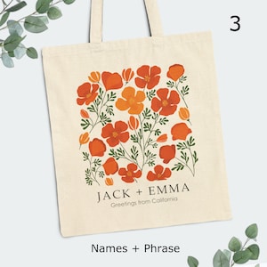 May include: A white tote bag with a floral design featuring orange and red poppy flowers. The text "JACK + EMMA Greetings from California" is printed on the bag.