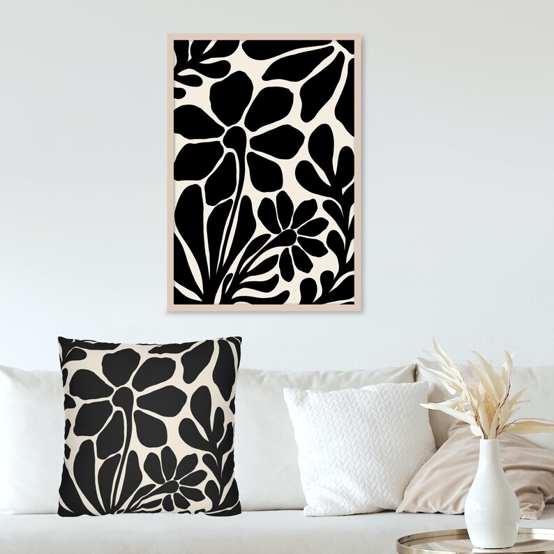 May include: Black and white floral print art print with a cream background. The print features large, stylized flowers and leaves.