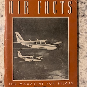 May include: A vintage magazine cover for Air Facts, a magazine for pilots. The cover features a black and white photo of two small airplanes flying over a bridge. The text on the cover reads "Air Facts" and "The Magazine for Pilots". The date on the cover is October, 1965.