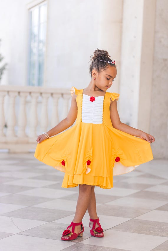 white dress with orange shoes Side View of Young Woman Wearing Fluffy Orange Halter Dress, White Shoes, Standing with Raised Leg on White Background. Stock Photo