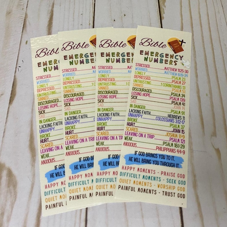 May include: Four Bible Emergency Numbers bookmarks. Each bookmark features a list of emotional states and corresponding Bible verses. The bookmarks have a cream background with black and colored text.