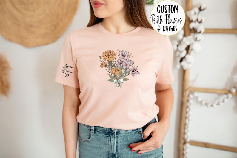 a woman wearing a pink t - shirt with flowers on it