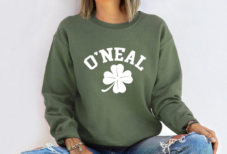 a woman wearing a green sweatshirt with a shamrock on it