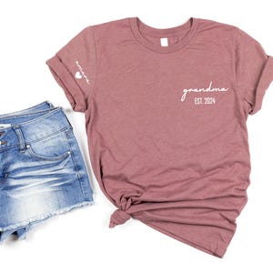 a t - shirt that says grandma on it next to a pair of shorts