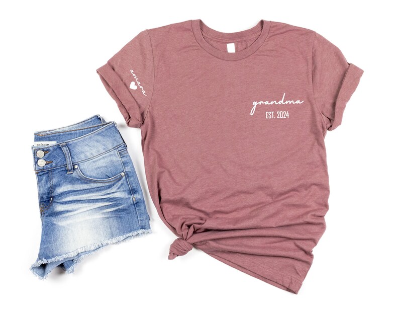 a t - shirt that says grandma on it next to a pair of shorts