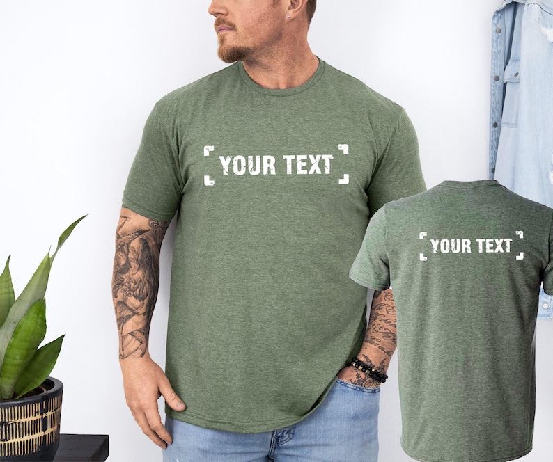 a man standing next to a plant wearing a t - shirt that says your text