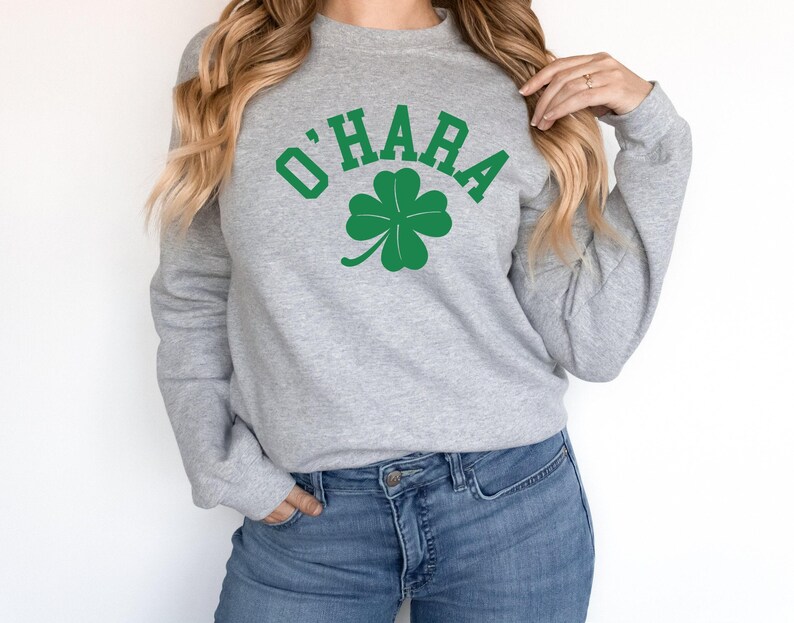 a woman wearing a sweatshirt with a shamrock on it