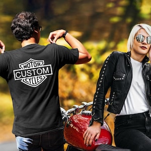 a man and a woman standing next to a motorcycle