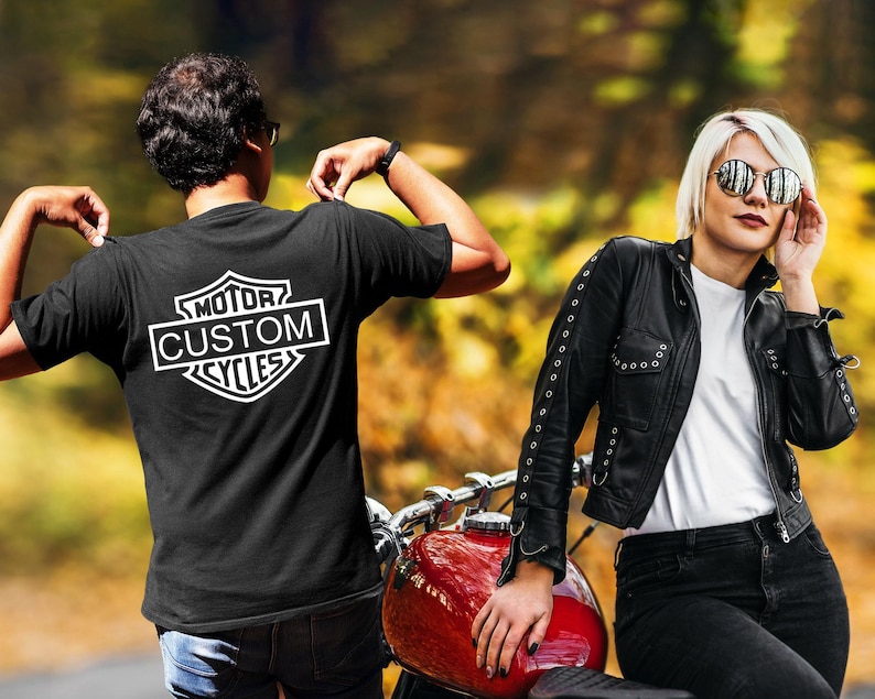 a man and a woman standing next to a motorcycle