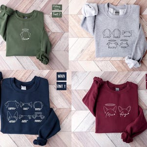 a group of four sweaters sitting on top of a wooden floor