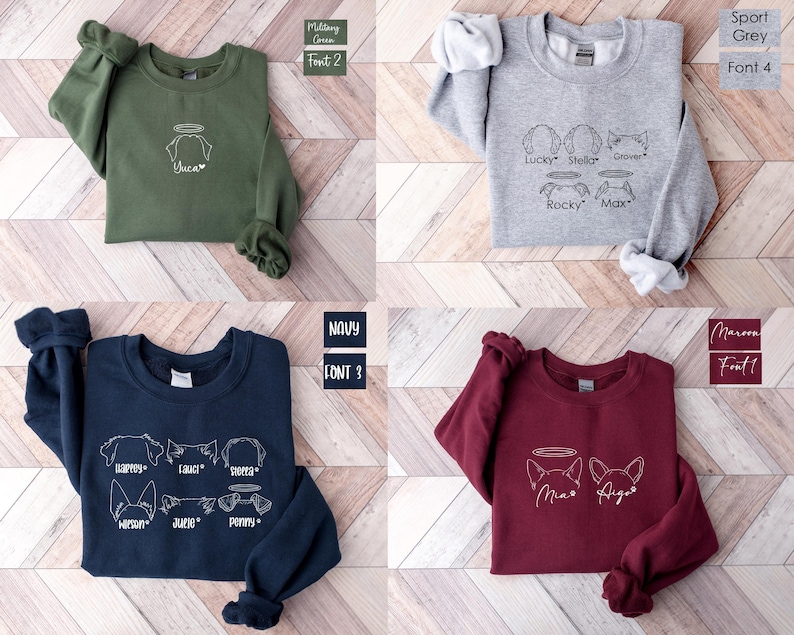 a group of four sweaters sitting on top of a wooden floor