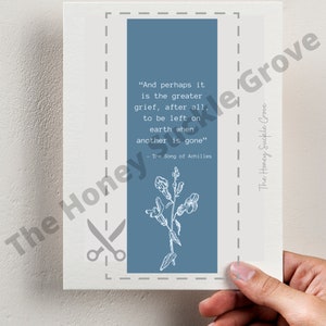 May include: A 4x6 inch print with a blue background and white text. The text reads "And perhaps it is the greater grief, after all, to be left on earth when another is gone" - The Song of Achilles. A white floral illustration is in the bottom half of the print.
