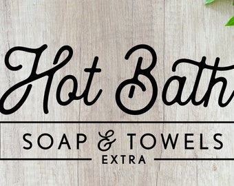 Peut inclure: Logo noir et blanc sur fond de bois avec le texte "Hot Bath Soap & Towels Extra".
