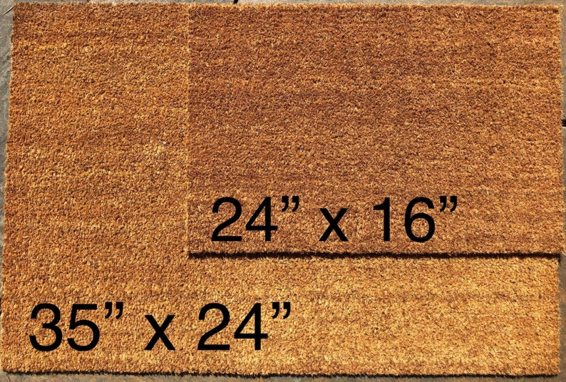 May include: Two rectangular doormats made of natural brown coir fiber. The larger mat measures 35" x 24", and the smaller one is 24" x 16". The mats are designed for outdoor use and are likely used to wipe shoes.