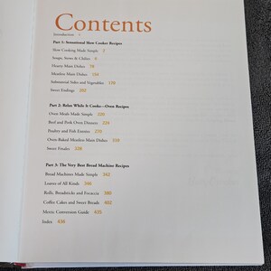 May include: Open cookbook page with the title "Contents" in a warm orange font. The table of contents lists recipes for slow cooker, oven, and bread machine dishes. The book includes a metric conversion guide and an index.