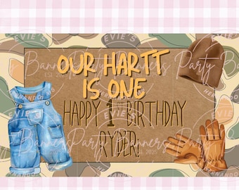 May include: A digital design for a first birthday party banner. The banner features a brown background with the text "OUR HARTT IS ONE HAPPY 1ST BIRTHDAY RYDER". Illustrations include denim overalls, a brown beanie, and work gloves.