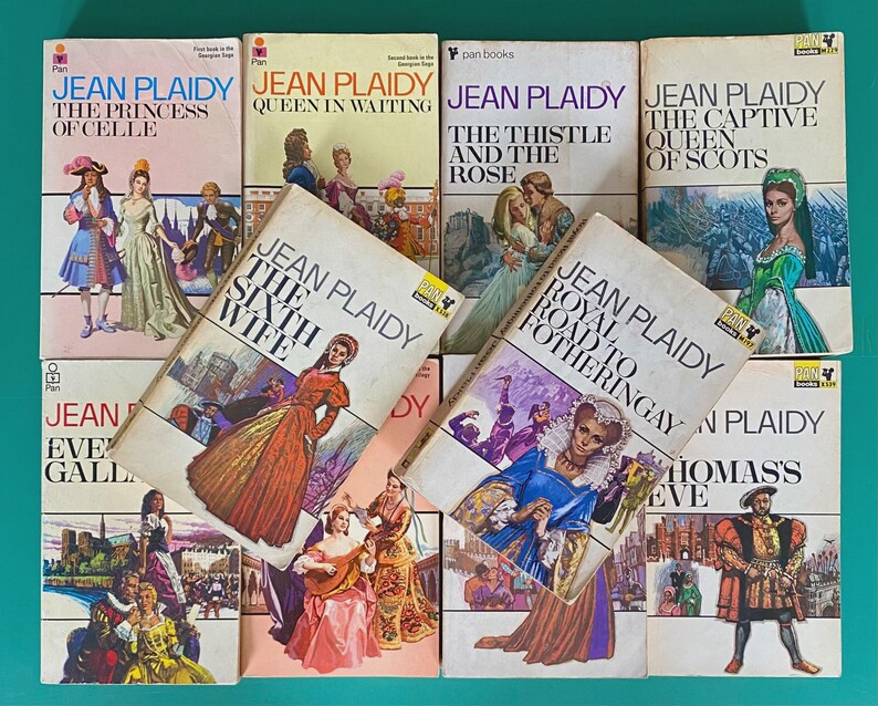 May include: A selection of vintage Jean Plaidy paperback books, including titles such as "The Princess of Celle," "Queen in Waiting," and "The Sixth Wife." The covers display illustrations of historical scenes and figures, typical of the period.