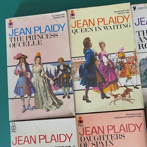May include: A selection of vintage Jean Plaidy paperbacks. The book covers display illustrations of historical figures in period dress. Titles include "The Princess of Celle" and "Queen in Waiting."