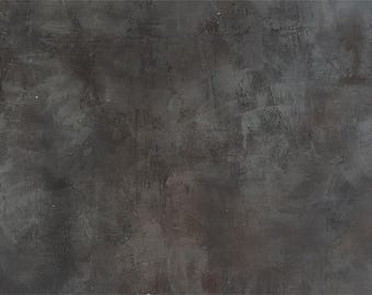 May include: A dark grey textured background with a rough, uneven surface.