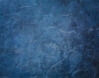 May include: A textured blue background with a slightly darker blue hue in the top right corner.