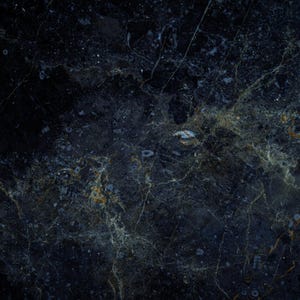 May include: A dark blue marble surface with a swirling pattern of lighter blue and gold veins.