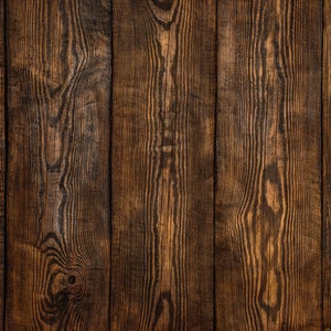 May include: Dark brown wood paneling with a vertical grain pattern. The wood has a rustic, weathered look.