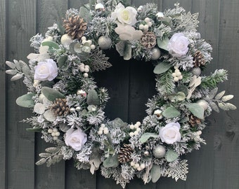 Snowy Christmas wreath for your front door, with roses, frosted pinecones, white and silver balls