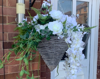 Image of Hanging basket filled with hydrangeas and other flowers