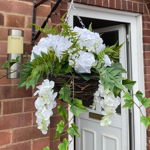 White round artificial hanging basket, with hydrangeas, roses, wisteria, fern and gypsophila. Summer baskets