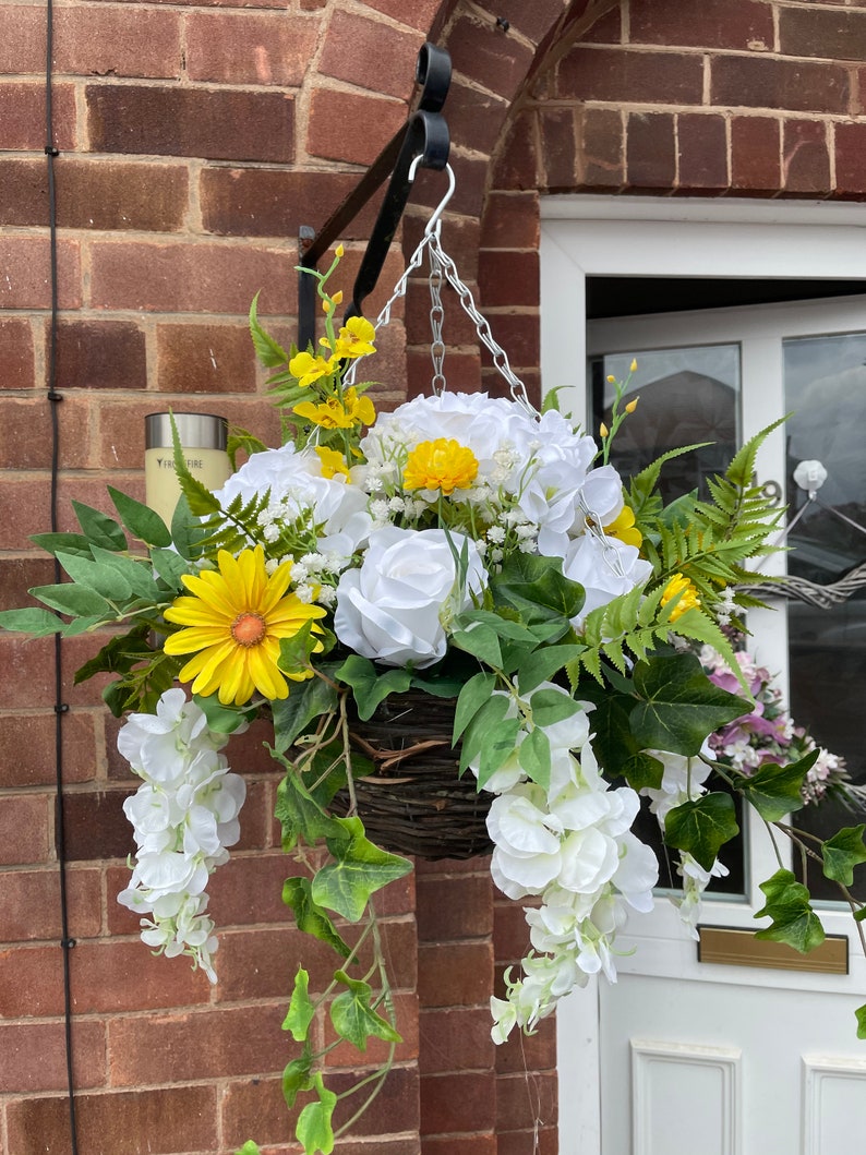 White round artificial hanging basket, with hydrangeas, roses, wisteria, fern and gypsophila. Summer baskets Yellow