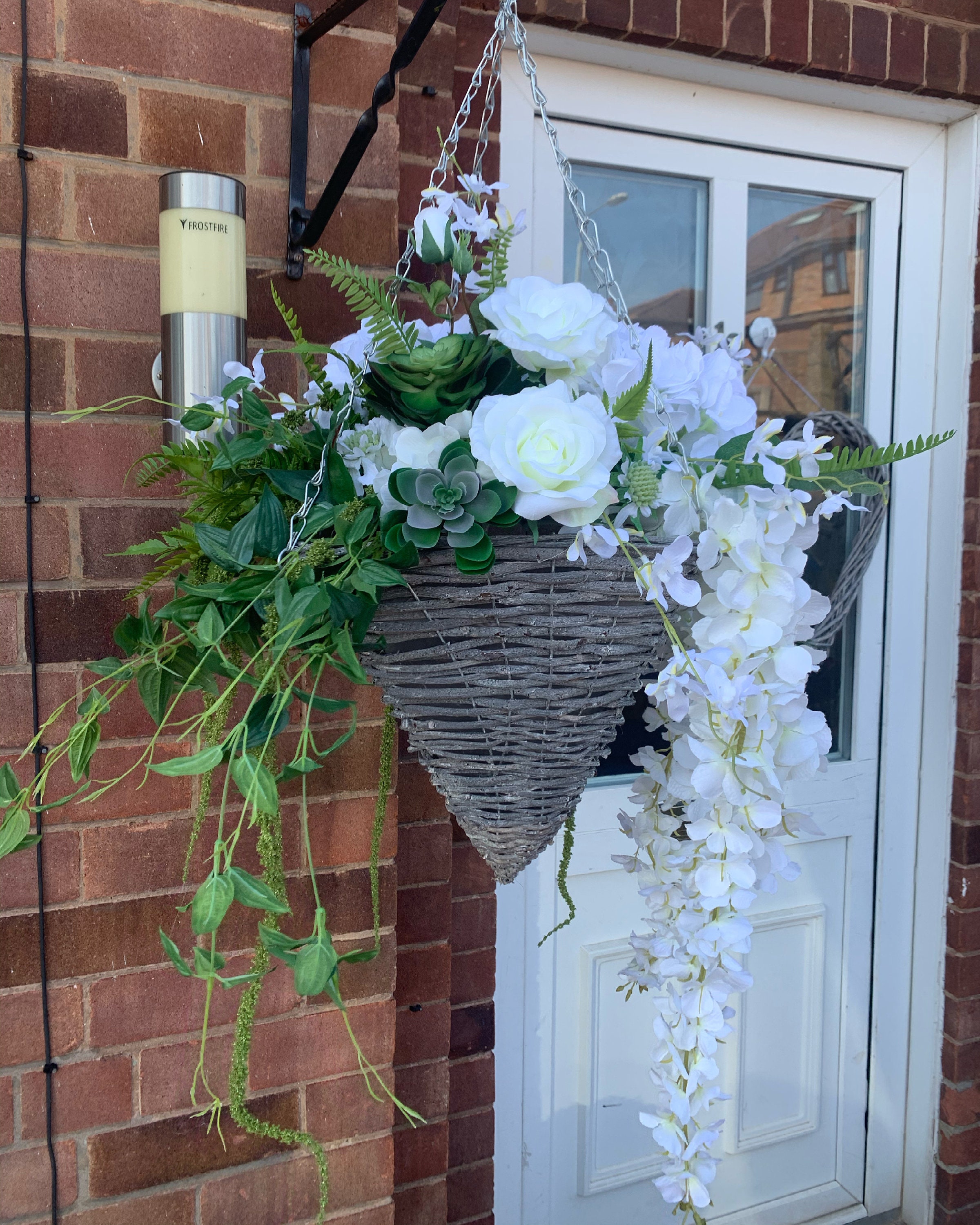 Image of Hanging basket filled with white hydrangeas
