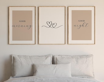 May include: A set of three framed wall art prints. The left print has a beige background with the black text "GOOD morning". The center print is white with a black line-art heart design. The right print has a beige background with the black text "GOOD night".