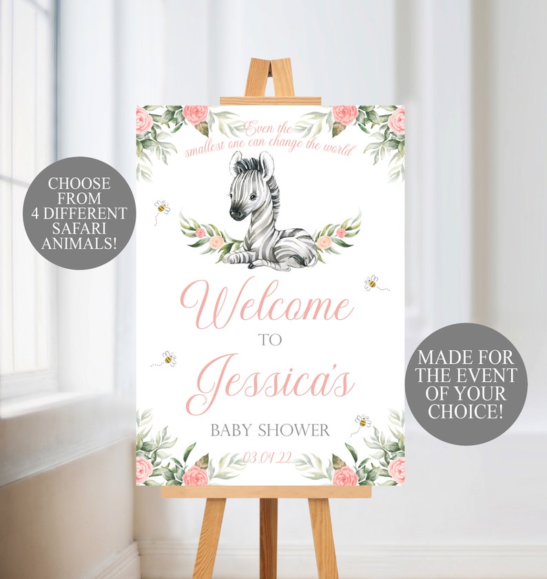 May include: A baby shower welcome sign on a wooden easel. The sign features a watercolor zebra illustration, floral accents, and the text "Welcome to Jessica's Baby Shower." Additional text includes "Choose from 4 Different Safari Animals!" and "Made for the Event of Your Choice!"