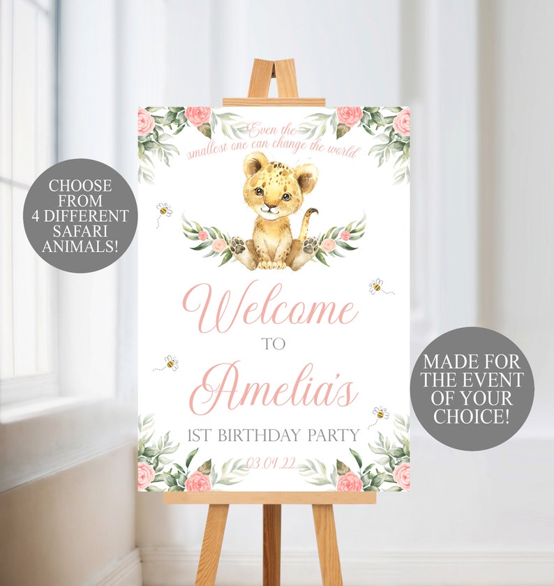 May include: A welcome sign for a 1st birthday party, featuring a watercolor illustration of a lion cub, flowers, and bees. The sign includes the text "Welcome to Amelia's 1st Birthday Party" and "Even the smallest one can change the world."
