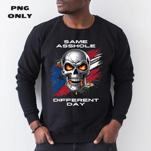 May include: Black sweatshirt with a skull graphic and the text "SAME ASSHOLE DIFFERENT DAY".