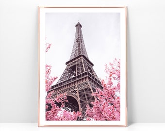 May include: A view of the Eiffel Tower in Paris, France, with pink cherry blossoms in the foreground.