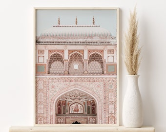 May include: A framed photograph of a pink and white building with intricate details and arches. The building has a domed roof and is decorated with geometric patterns.