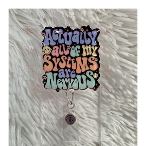May include: A black and white badge holder with a colorful, glittery, retro-style design that says "Actually all of my systems are nervous".