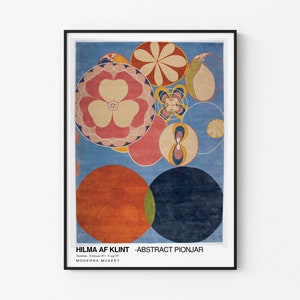 May include: A framed poster featuring an abstract painting by Hilma af Klint. The artwork depicts a blue background with overlapping circles in a range of colours, including red, orange, yellow, green, and pink. The circles incorporate geometric shapes and patterns. The poster includes the text "Hilma af Klint - Abstract Pionjar" and "Moderna Museet".
