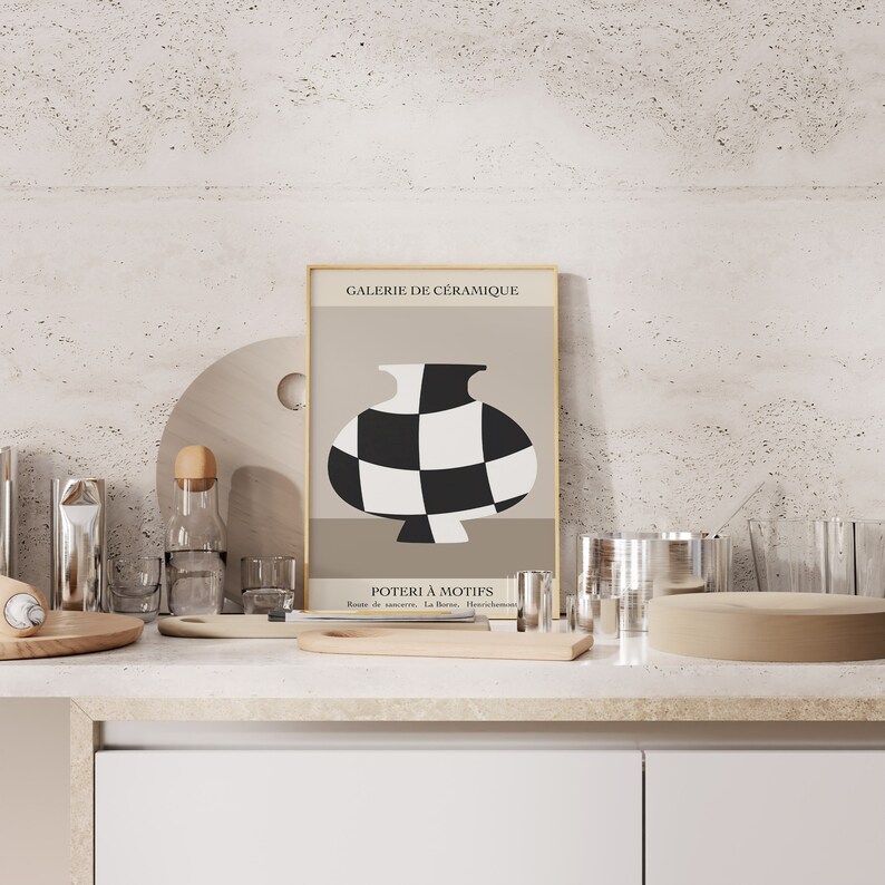 May include: A framed poster with a black and white checkered vase on a beige background. The poster is titled "Galerie de C&eacute;ramique" and "Poterie &agrave; Motifs".